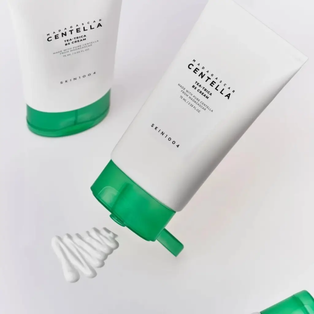 Two tubes of SKIN1004 Madagascan Centella Tea-Cream with green caps on a light gray background.