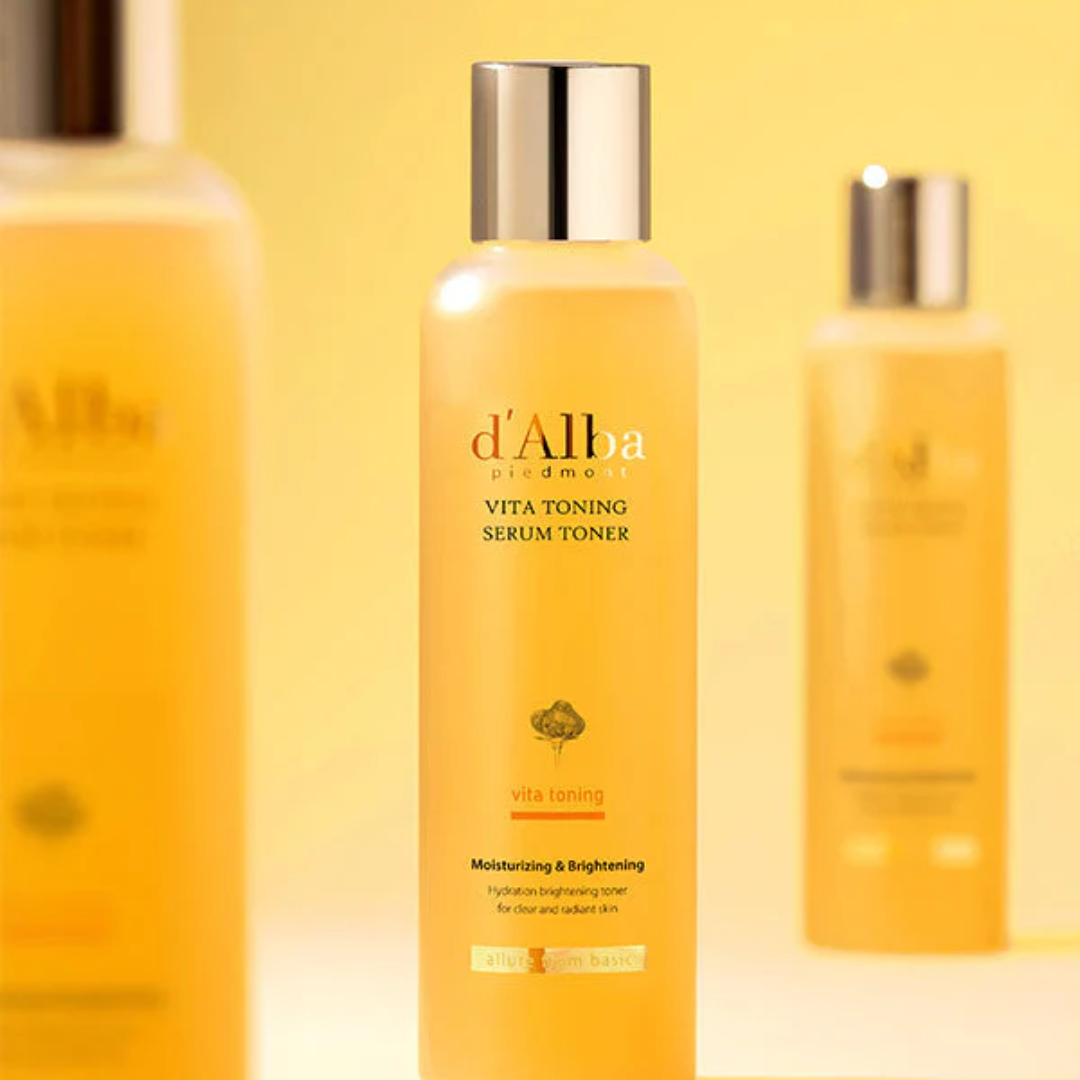 Three bottles of d'Alba skincare products on a yellow background
