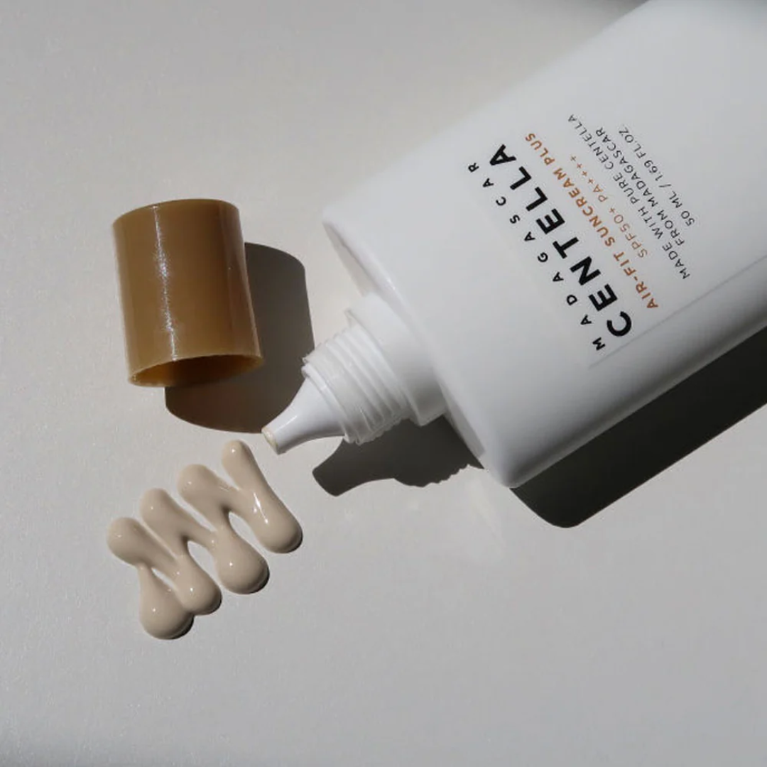 Cosmetic bottle with brown cap and visible product on a light background