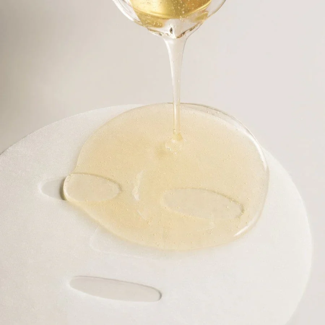 White wine being poured into a glass on a white background