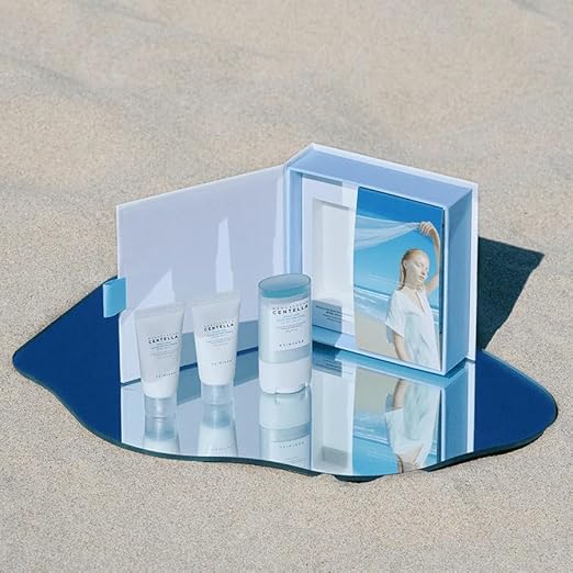 Cosmetic set with bottles and a mirror on a reflective surface