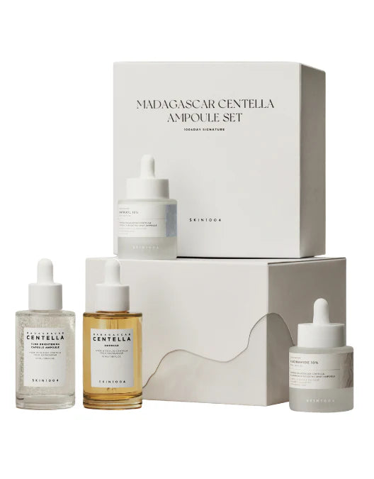 Skincare set with bottles and a box labeled 'Madagascar Centella Ampoule Set' on a white background.