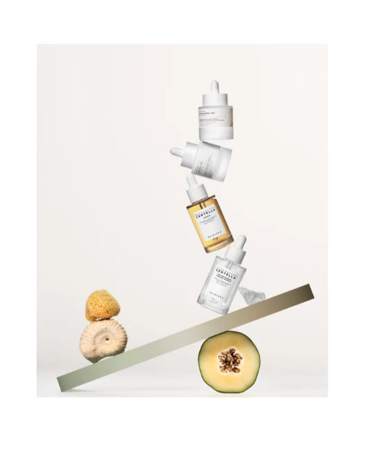 Skincare products with a melon and brush on a light background