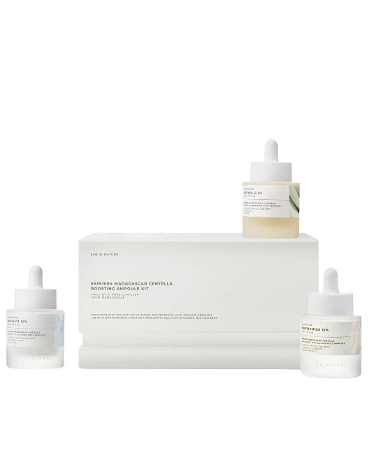 Skincare product set with bottles and a box on a white background