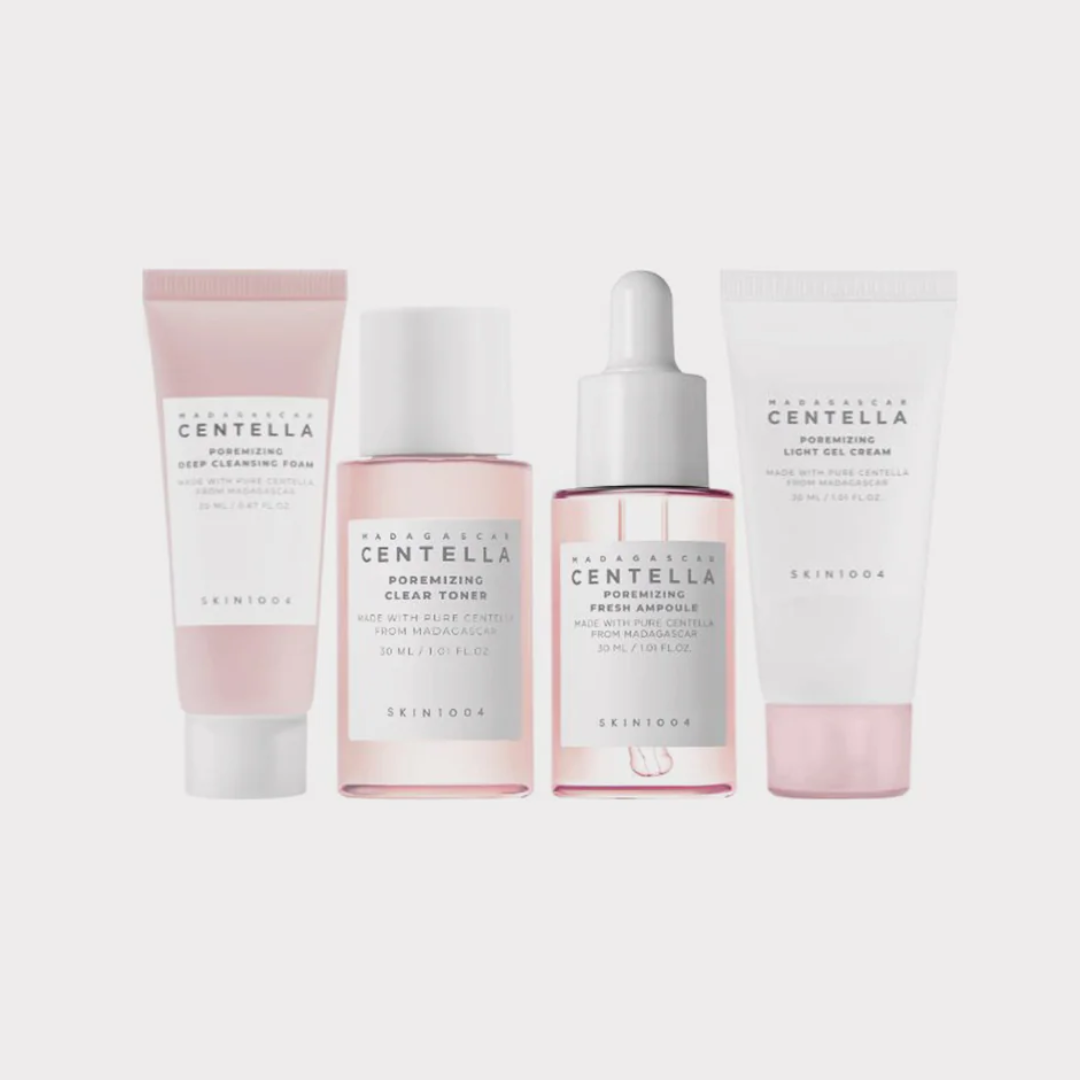 Set of skincare products with pink and white packaging on a light gray background