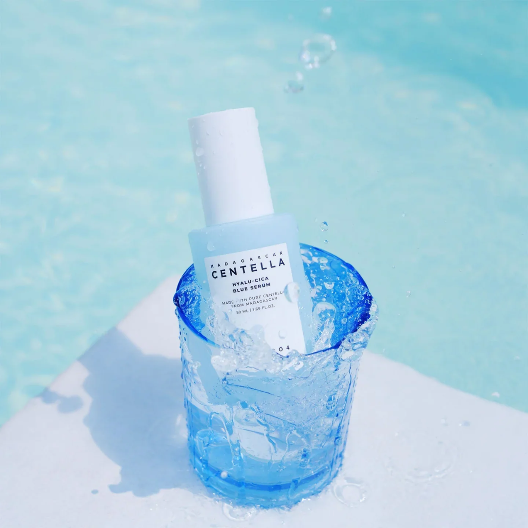 Centella Asiatica skincare serum in a blue glass with a light blue background