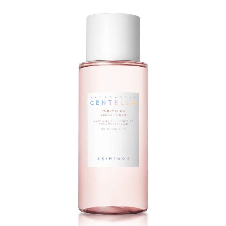 Skincare bottle with pink liquid and white cap on a white background