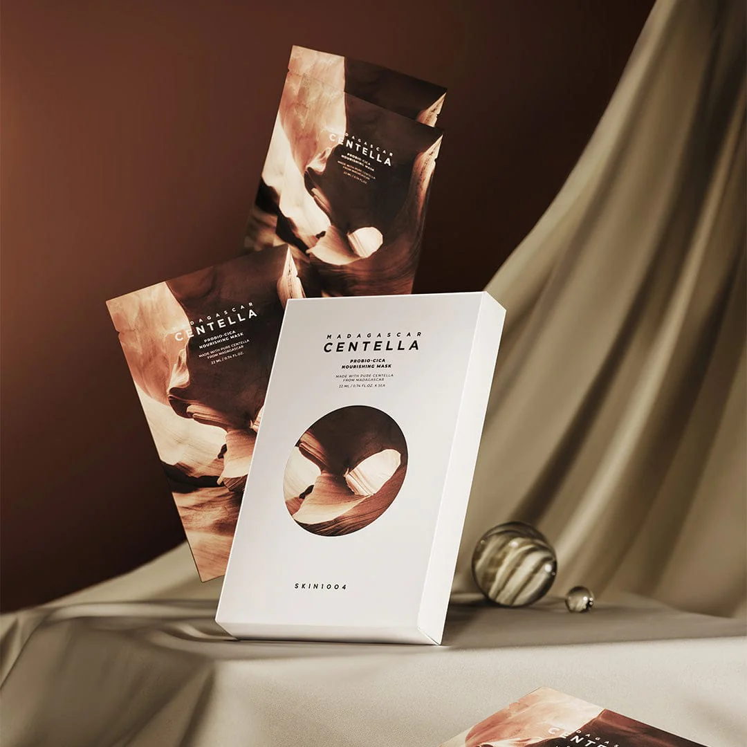 Skincare product packaging with 'Centella' branding on a draped fabric background