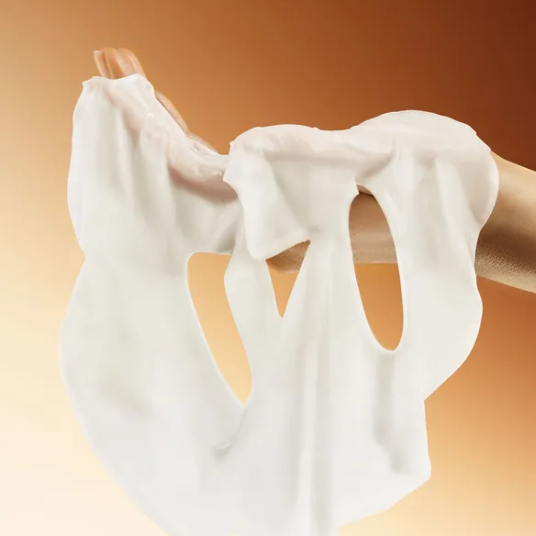 SKIN1004 mask in a hand with brown gradient background