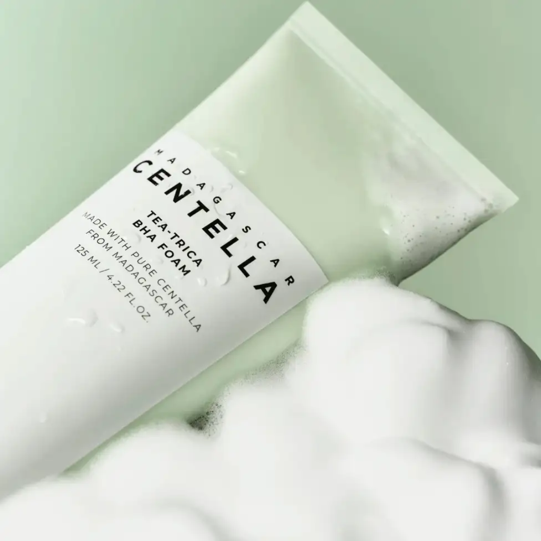 Tube of Madagascan Centella Asiatica BHA foam with a foamy texture on a green background