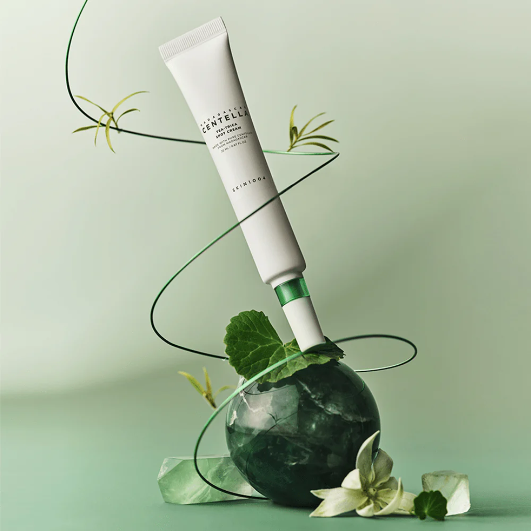 Skincare tube with green leafy elements on a light green background