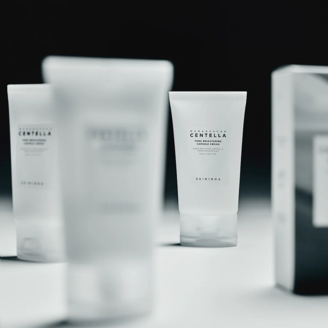 Skincare products with 'CENTELLA' branding on a blurred background