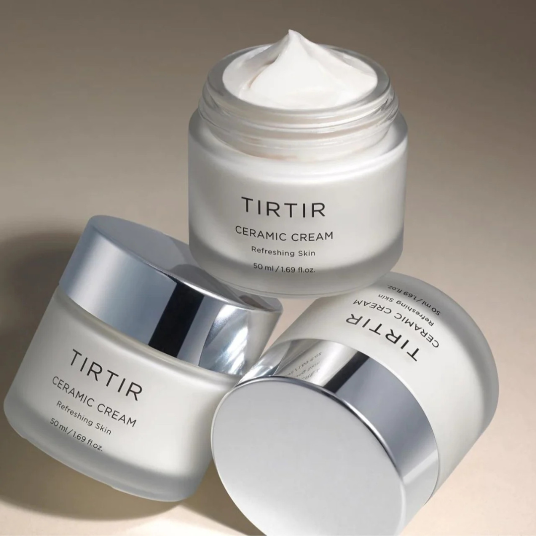 Three jars of TIRTIR Ceramic Cream on a beige background