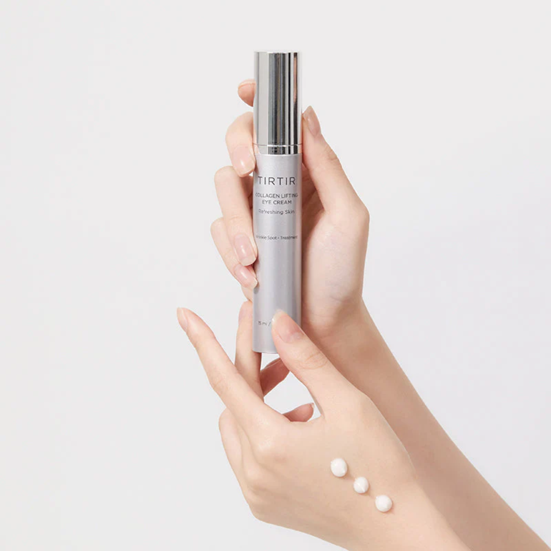 Hand holding a skincare bottle with a plain background