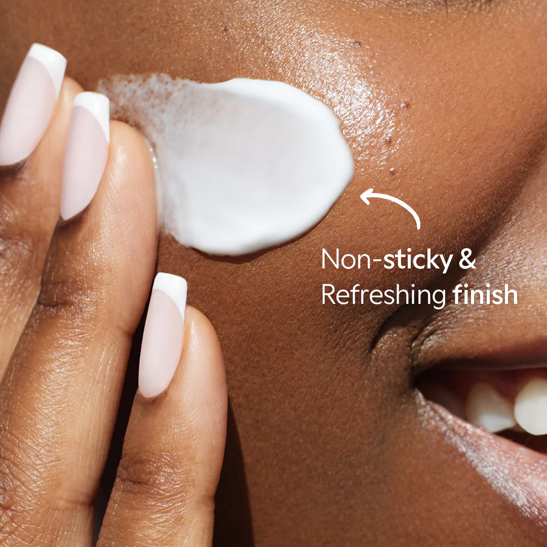 Hand applying a non-sticky skincare product to skin with text overlay