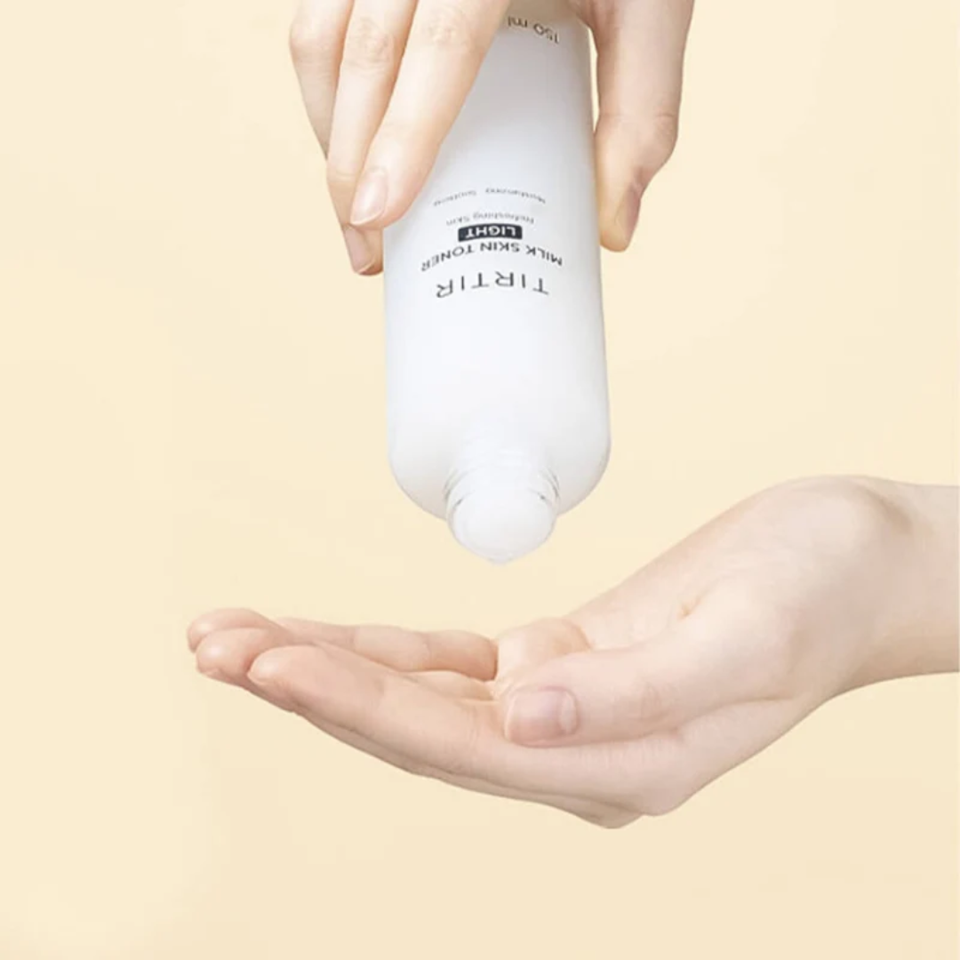 Hand holding a white bottle labeled 'TIRER' above another hand on a beige background
