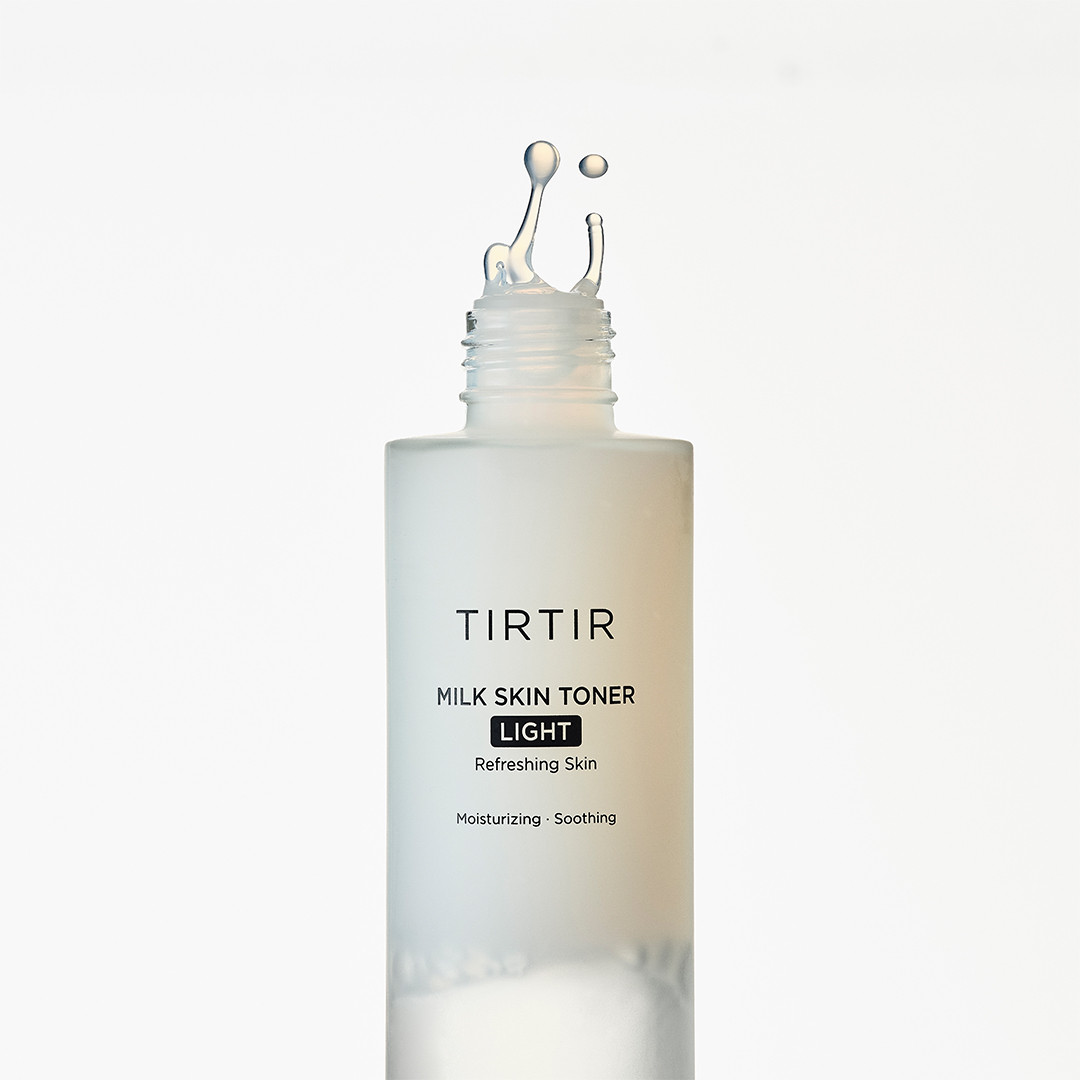 TIRTIR Milk Skin Toner Light bottle with droplet on a white background