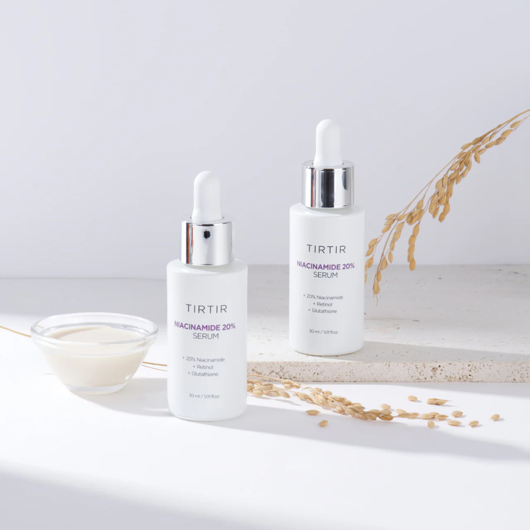 Two skincare serum bottles labeled 'TIRIR' on a marble surface with a light background.