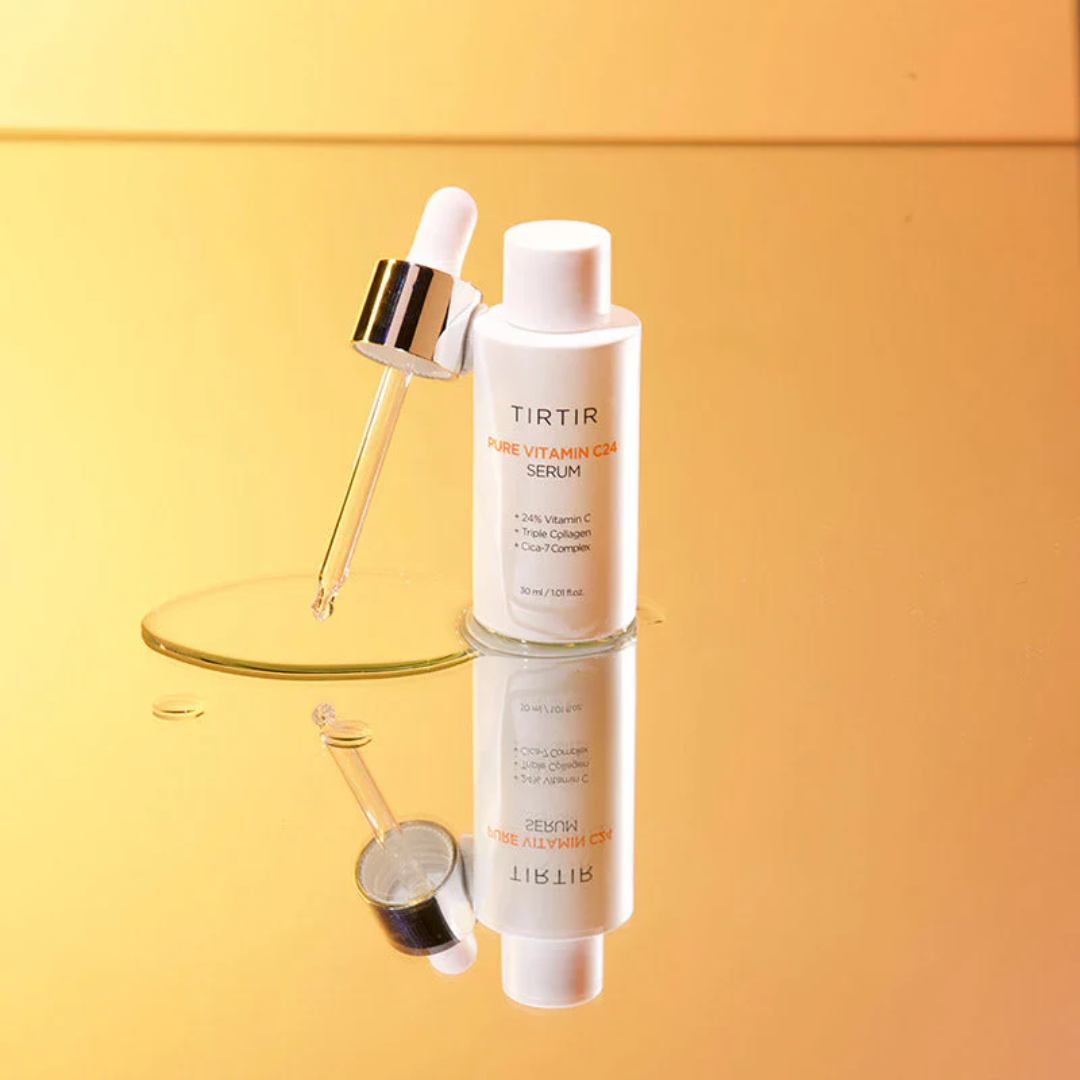 TIRTIR Pure Vitamin C Serum bottle with dropper on a reflective surface against a gradient yellow background