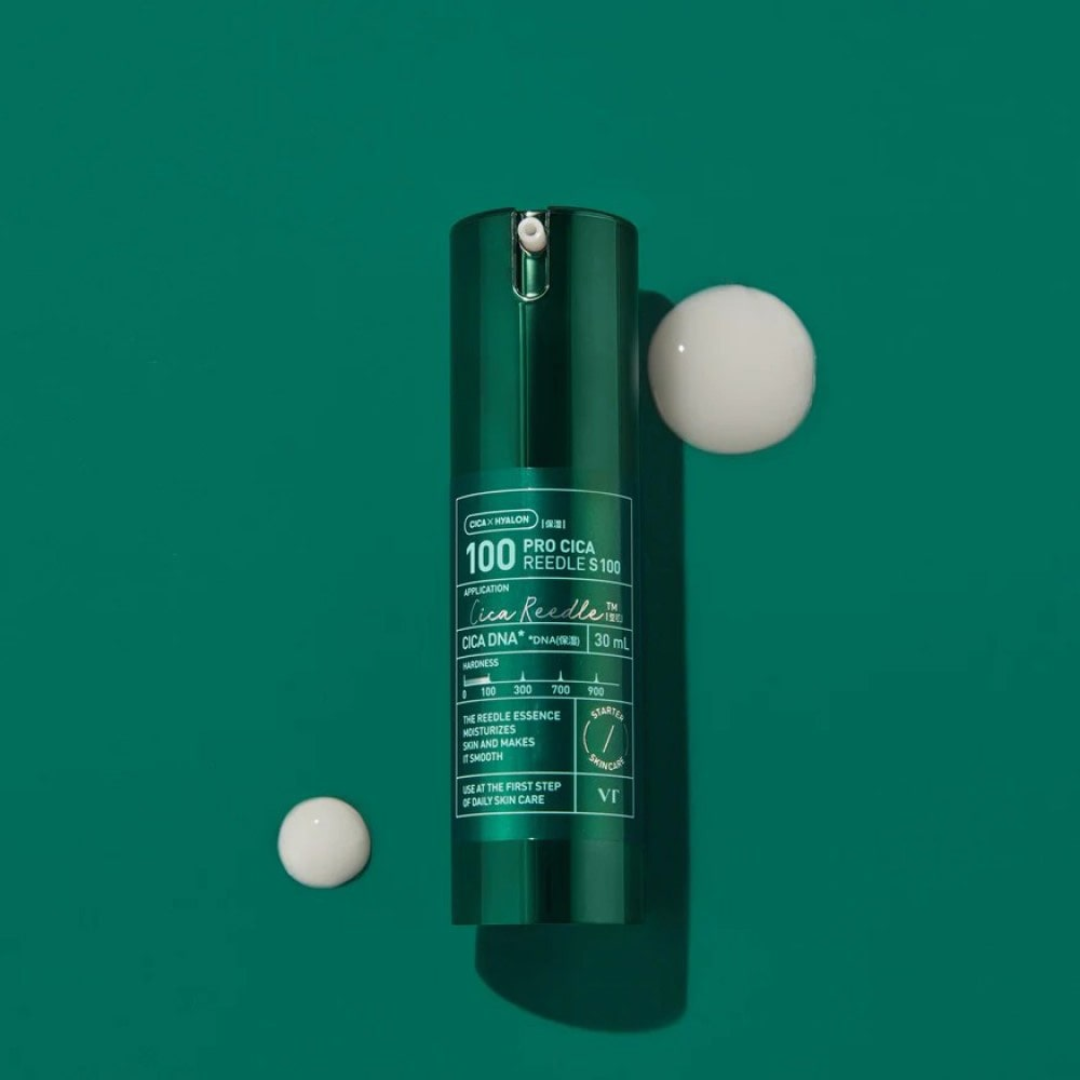 Green skincare bottle with two white capsules on a green background