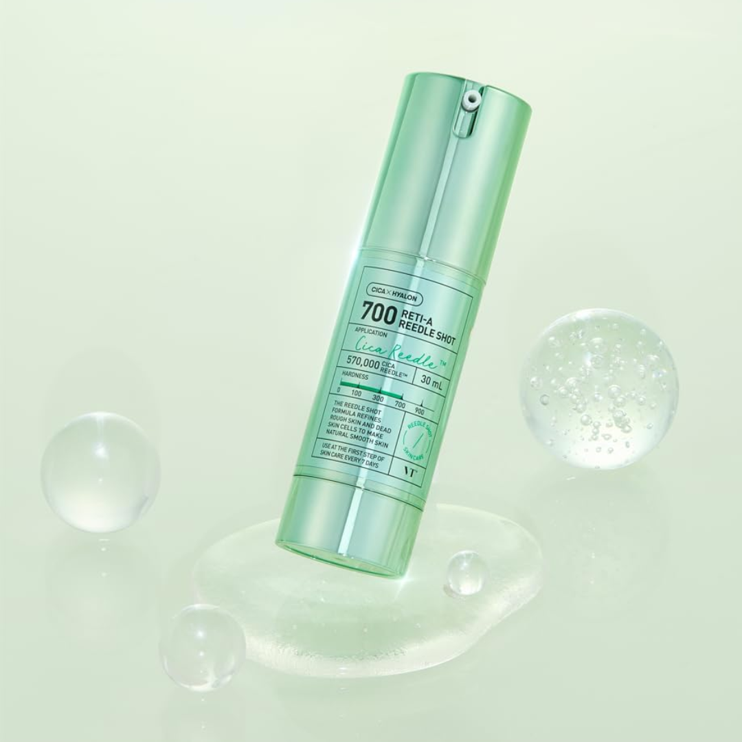 Green skincare bottle with droplets on a light green background